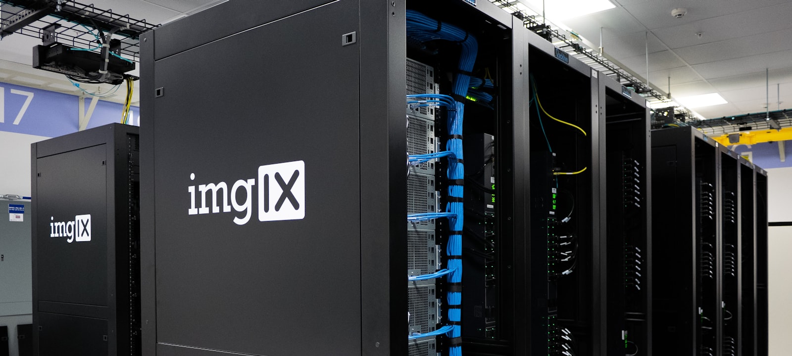 Server racks lit in blue inside a data center